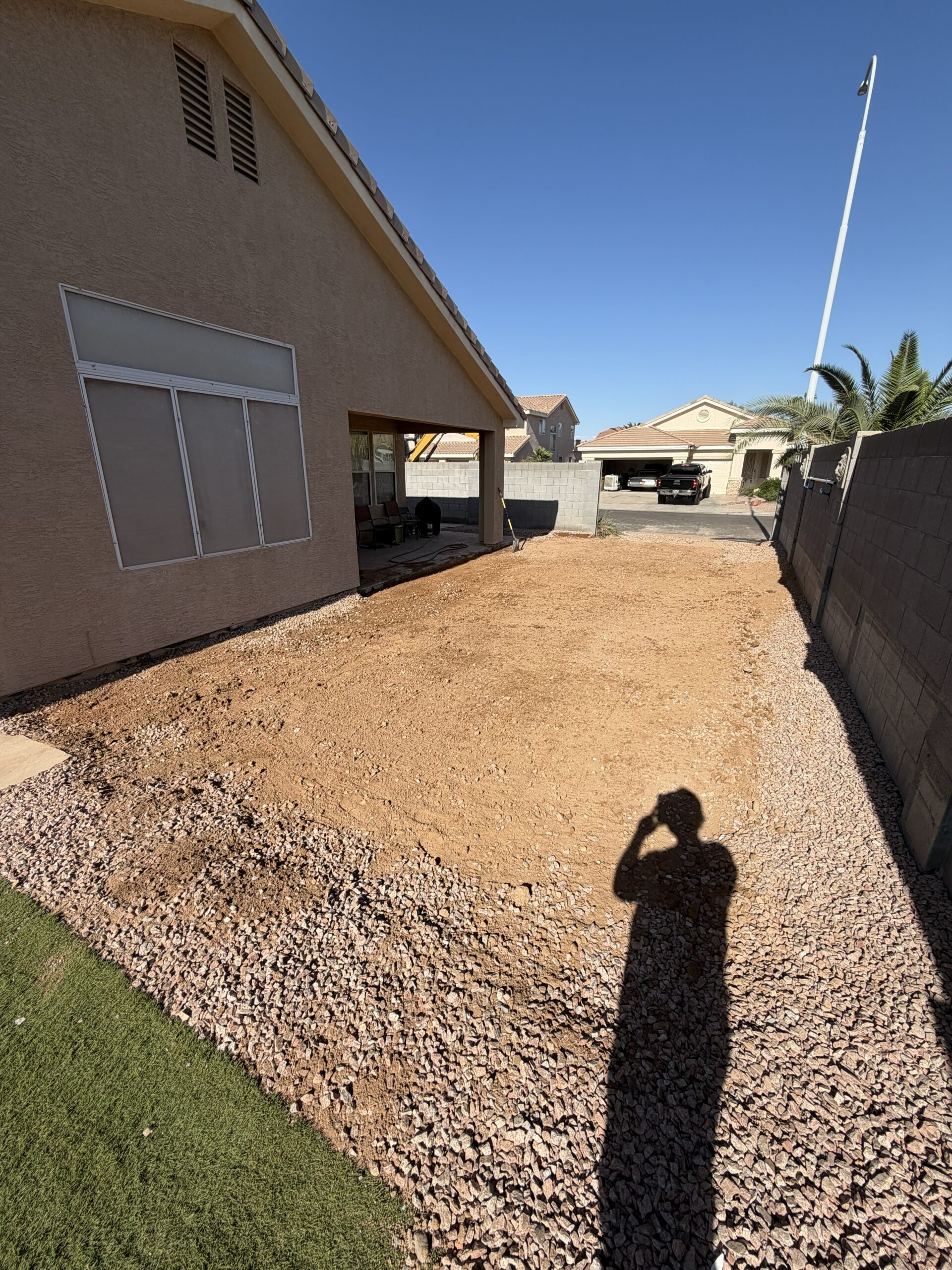 Residential pool demolition and debris removal project in the East Valley with demolition contractor equipment on-site.